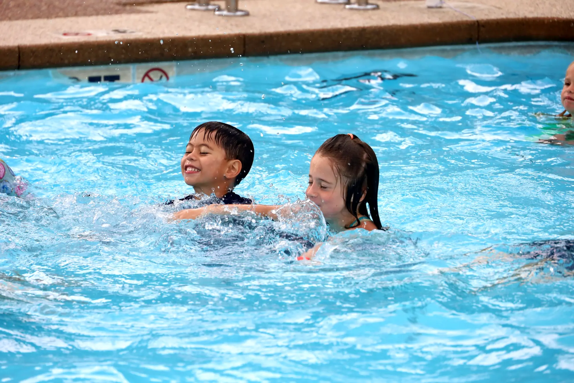 Children building confidence together in the pool