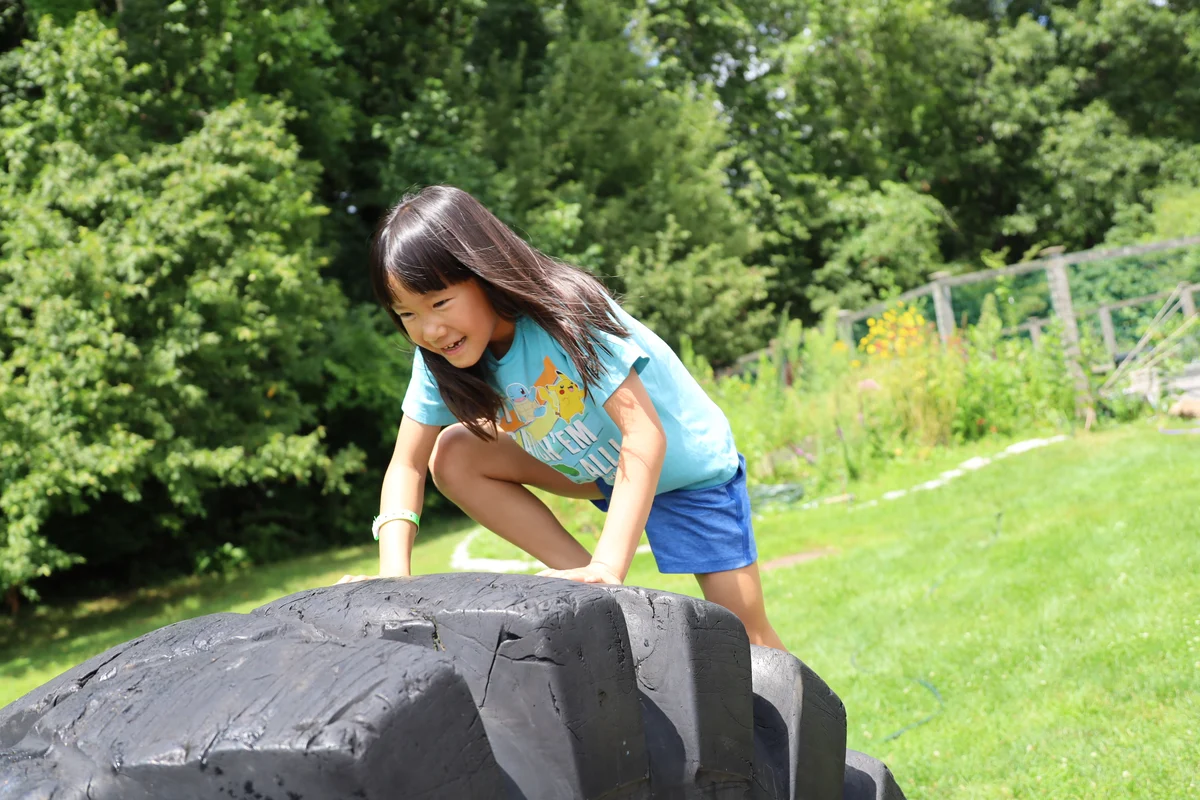 An Adventurer tackling an outdoor tire obstacle